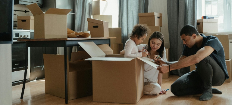 A family surrounded by boxes.