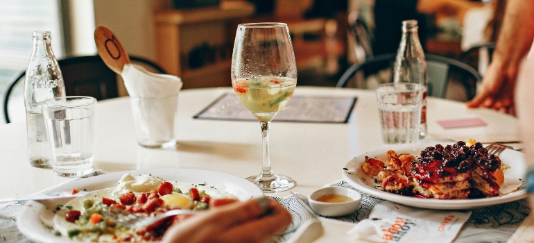 People dining out at a restaurant in Virginia, highlighting varied dining costs by location.