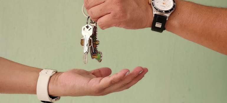 man giving another man keys