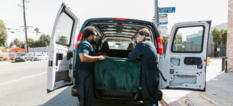 Vinton movers packing a couch into a van.