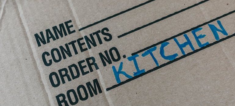 a moving box with kitchen stuff inside