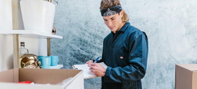A man is writing notes for moving, working with movers in South Boston, VA.