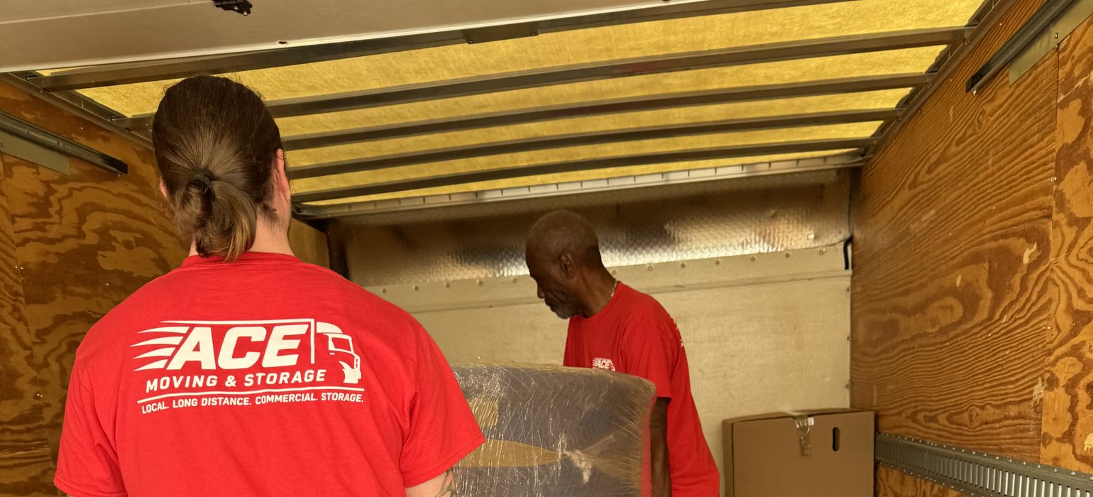 Ace Moving and Storage movers carrying a wrapped chair into a truck, residential movers Virginia