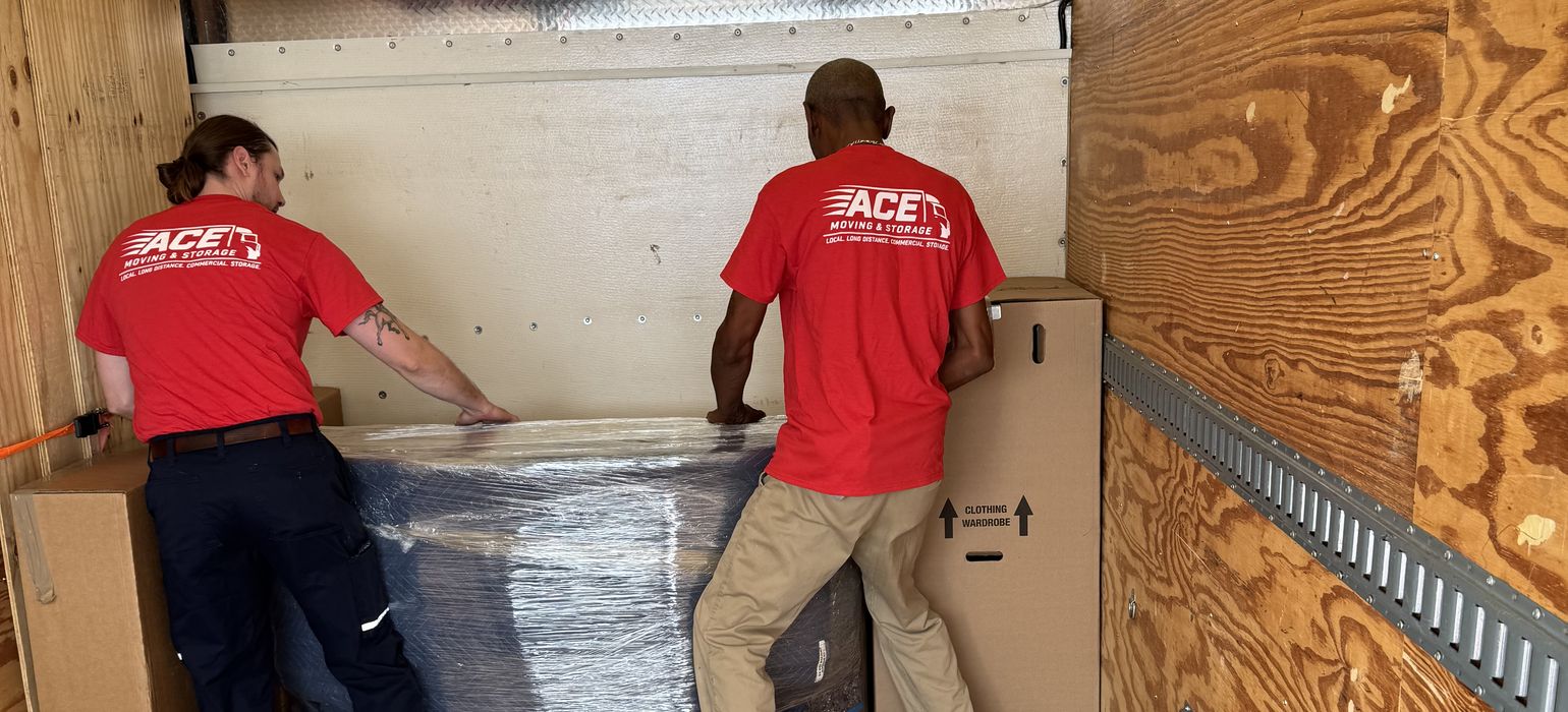 Ace Moving and Storage movers loading wrapped furniture into a moving truck for an interstate move