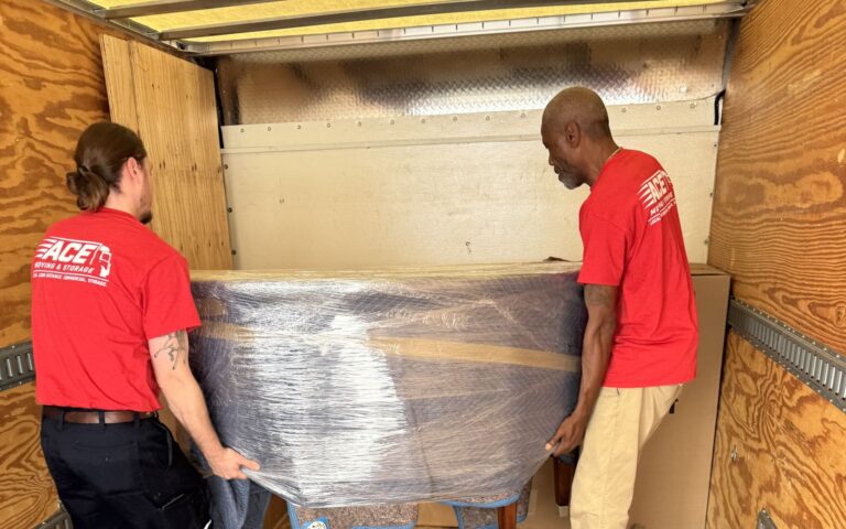 Ace Moving and Storage crew loading a wrapped table into a truck in Roanoke, VA